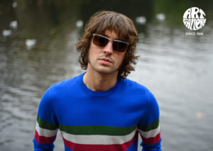 ART GALLERY CLOTHING SIXTIES STYLE KNITWEAR SCENE Azzurri blue, crew neck pullover with isle green, off white & red horizontal placed stripes on body front, back & sleeves.
